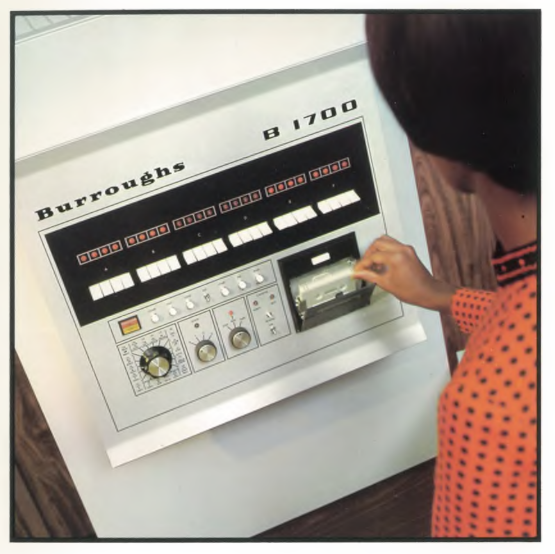 A woman operating a Burroughs 1700 computer